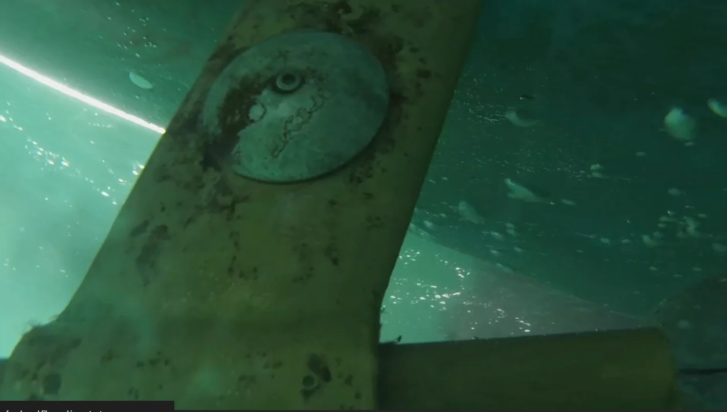 Diver installing a new zinc anode on a boat propeller shaft underwater in Victoria BC